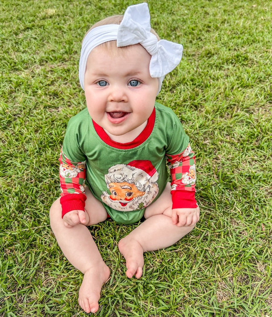Jolly Santa Bubble: A long-sleeve onesie in green with Christmas plaid sleeves and red trim, featuring vintage-looking Santa designs.