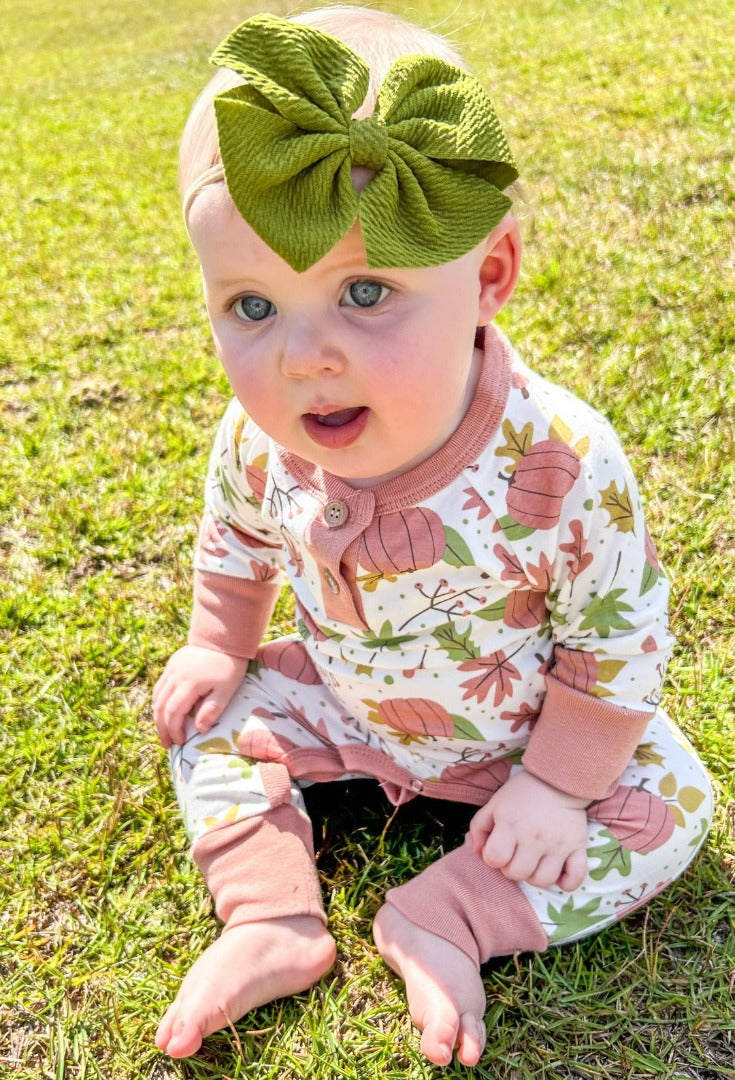 Girls' Falling for Fall Onesie with a white background, featuring pink pumpkins, green, gold, and pink leaves, branches, and acorn designs, accented with pink trim.