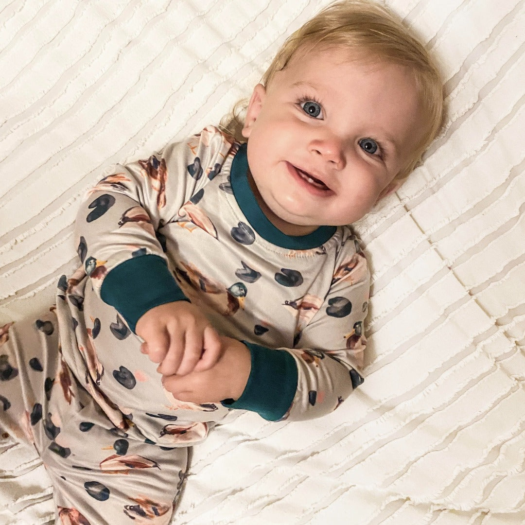 Boys' Fall Duck Pajama Set on a tan background with various duck designs and blue trim.