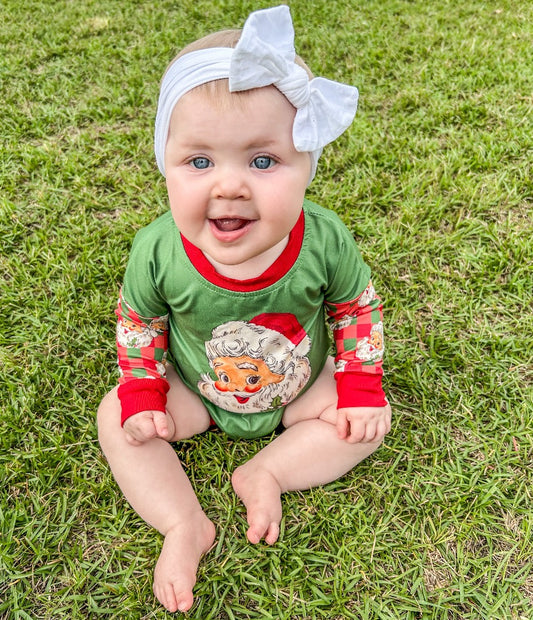 Jolly Santa Bubble: A long-sleeve onesie in green with Christmas plaid sleeves and red trim, featuring vintage-looking Santa designs.